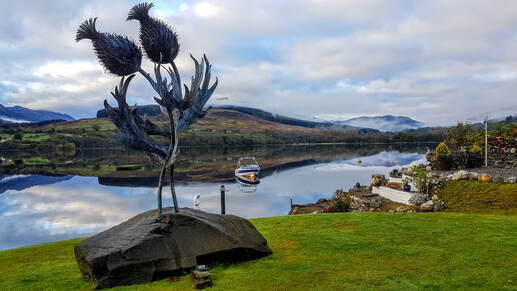 Thistle sculpture by Kev Paxton, Briar Cottages garden Loch Earn
