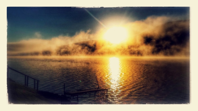 Ethereal sunrise in mist Loch Earn
