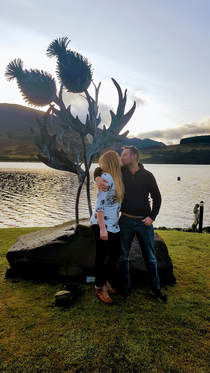 Couple get engaged at the thistle sculpture in Briar Cottages garden Loch Earn