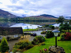 view from Little Briar Cottage over the landscaped gardens and Loch Earn