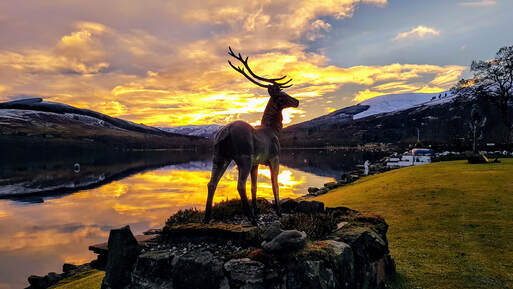 Fiery Sunset behind Stan The Stag Loch Earn